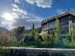a building with the sun in the sky at THE WILLOW HOUSE in Leh
