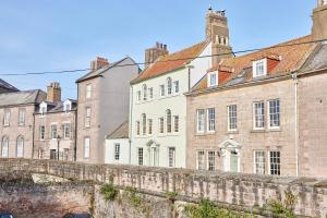 a row of old buildings in a city at River View: Characterful Townhouse, Stunning Views in Berwick-Upon-Tweed