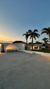 a large parking lot with palm trees in the background at Santorini Guesthouse in Amanzimtoti