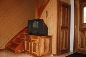 a tv sitting on a wooden cabinet in a room at Chalet Zwächta in Zermatt