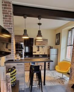 a kitchen with a large table and yellow chairs at villa l'Ambroisine in Lure