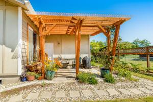 a patio with a wooden pergola on a house at Stella Maris in Westport
