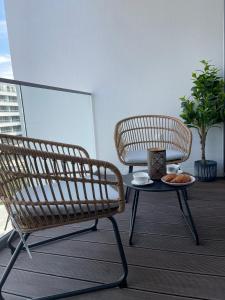 a balcony with a bench and a table with a bowl of food at Apartament Nadmorski - Plac Unii - Parking in Gdynia