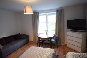 a living room with a couch and a table at Johnny House in Suwałki