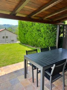 a black table and chairs on a patio at Maison Bric in Millesimo