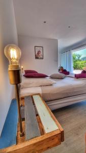 a bedroom with two large beds and a lamp at La maison du bonheur in Cotignac