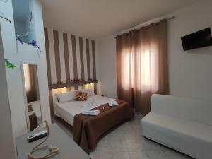 una camera d'albergo con letto e divano di Ely Sea a Belvedere Marittimo