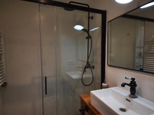 a bathroom with a shower and a sink and a mirror at Apartament Monticalvari in Sant Feliu de Guíxols