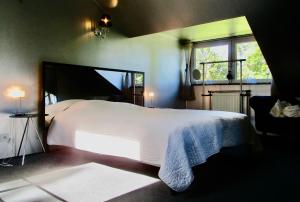 a bedroom with a large white bed and a window at Le Relais des Fagnes in Sart-lez-Spa