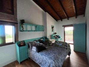 a bedroom with a bed in a room with a window at Rural Norte in Bañugues