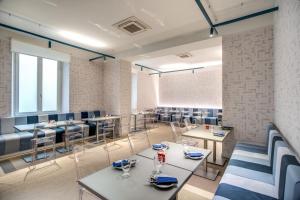 a restaurant with tables and chairs in a room at Hotel De Lanzi in Florence