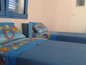 Кровать или кровати в номере Casa Azzurra Felloniche