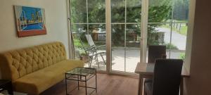 a living room with a couch and a large window at Haus Schranz, Fuhrmannsloch in Nauders