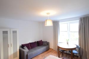 a living room with a couch and a table at Johnny House in Suwałki