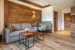 a living room with a couch and a table at Hotel Pramstraller in Mayrhofen