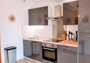 a kitchen with a sink and a stove at Le Petit Saint Jean - Residadigne - Zeperfectplace in Digne-les-Bains