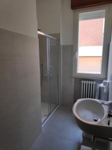 a bathroom with a sink and a shower at Appartamento Panoramica in Pesaro