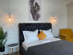 a bedroom with a bed with a book on it at VILA MRV in Constanţa