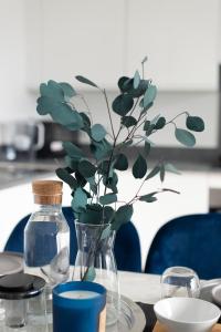a vase with a plant in it on a table at Luxury penthouse with stunning views near Canary Wharf in London
