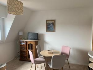 comedor con mesa y sillas en Petit appartement cosy en Villers-sur-Mer