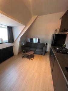 a living room with a couch in a loft at Studio Wijkhuizen in Zandvoort