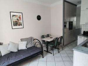 a living room with a couch and a table in a kitchen at Appartement au n°1 centre d'Avranches in Avranches +1 photo