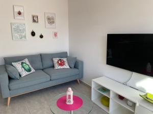 sala de estar con sofá y TV en Villa de 2022 moderna y con piscina privada, en San Pedro del Pinatar