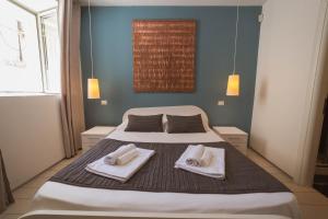 Letto o letti in una camera di Villino Erminia - Seaside Art b&b