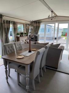 a dining room with a table and chairs at Heywoods caravan holiday home in Morecambe