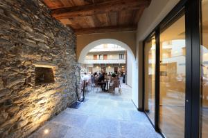 a stone wall in a restaurant with a fireplace at Charme Hotel al Torchio in Ascona