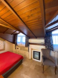 a bedroom with a red bed and a fireplace at Castle Old Town Hotel in Antalya