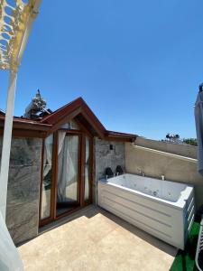 a bath tub sitting on top of a patio at Castle Old Town Hotel in Antalya