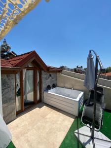 a hot tub sitting on the patio of a house at Castle Old Town Hotel in Antalya