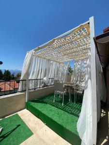 a patio with a table and chairs on a roof at Castle Old Town Hotel in Antalya