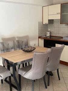 a dining room table with chairs and a kitchen at Apartment Isabell in Split