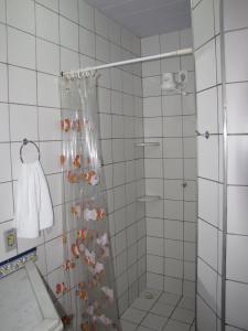 a bathroom with a shower with a shower curtain at Pousada 7 Mares in Canoa Quebrada