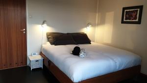 a bedroom with a bed with a backpack on it at Villa with great view in Sandnes