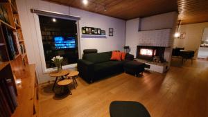 a living room with a couch and a fireplace at Villa with great view in Sandnes