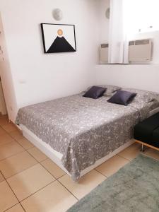 a bedroom with a bed in a white room at Apartment Ognissanti 1 - free parking in Koper