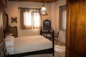 ein Schlafzimmer mit einem Bett, einem Fernseher und einem Fenster in der Unterkunft Villa marina " G " in Argassi