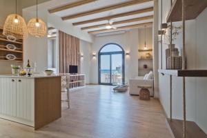 a large room with a kitchen with a large window at Olia Boutique Apartments in Karpathos Town
