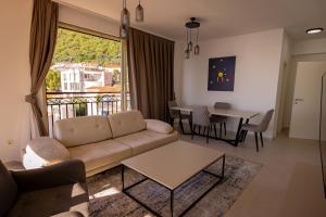 a living room with a couch and a table at Vertmont Villa in Sveti Stefan