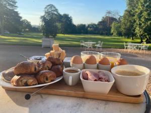 a tray of food on a table with eggs and meat at Château de Beauchamp- La chapelle de Guinchay in La Chapelle-de-Guinchay