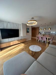 a living room with a couch and a table at Eternity Luxury Apartment Dolny Sopot in Sopot