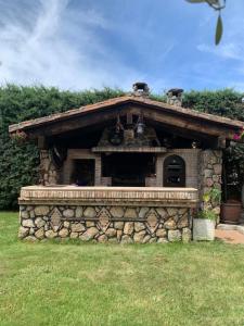 a small stone building with a stone wall at Casa Rural LOS TINES in Bustarviejo