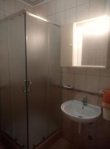 a bathroom with a shower and a sink at Dragica in Palit