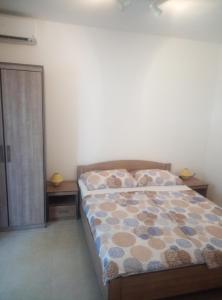 a bedroom with a bed and two night stands at Dragica in Palit