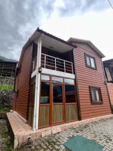 a large wooden house with a large wooden door at Kibar Home in Uzungol