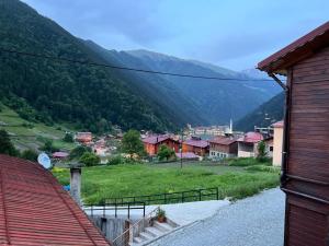 a small town in a valley with mountains at Kibar Home in Uzungol