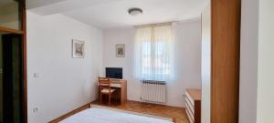 a white room with a desk and a window at Old Town Heritage by Mrav in Sukošan
